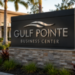 Illuminated commercial monument sign at a Southwest Florida business property during evening hours.