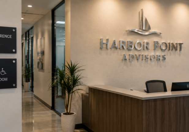 Dimensional lobby sign and ADA-compliant signage installed inside a professional Fort Myers business.
